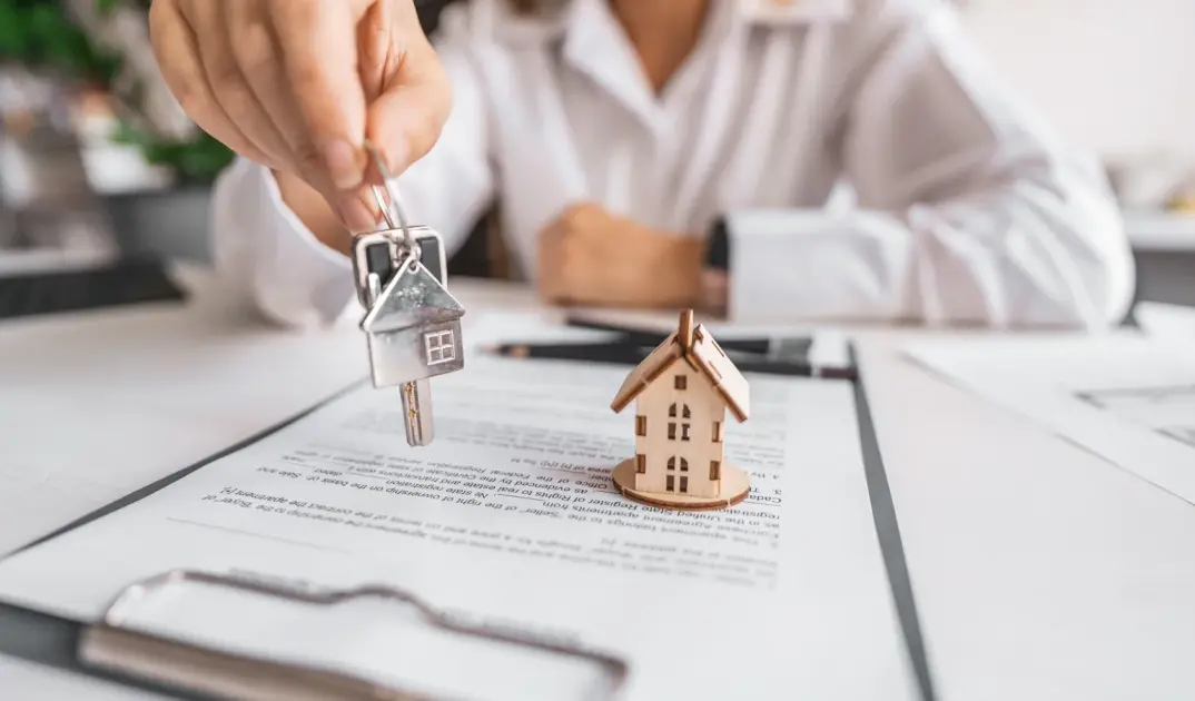 Asesor inmobiliario revisando con su cliente los documentos de una compraventa
